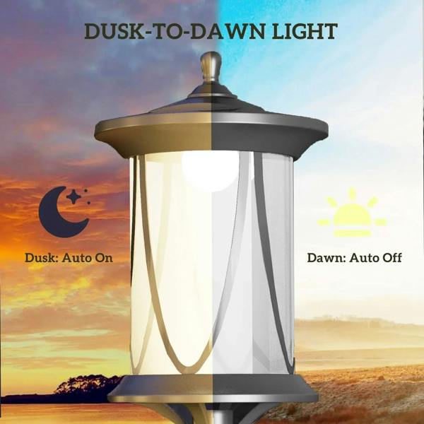 Black solar lamp post light with glass lantern shade and warm glow