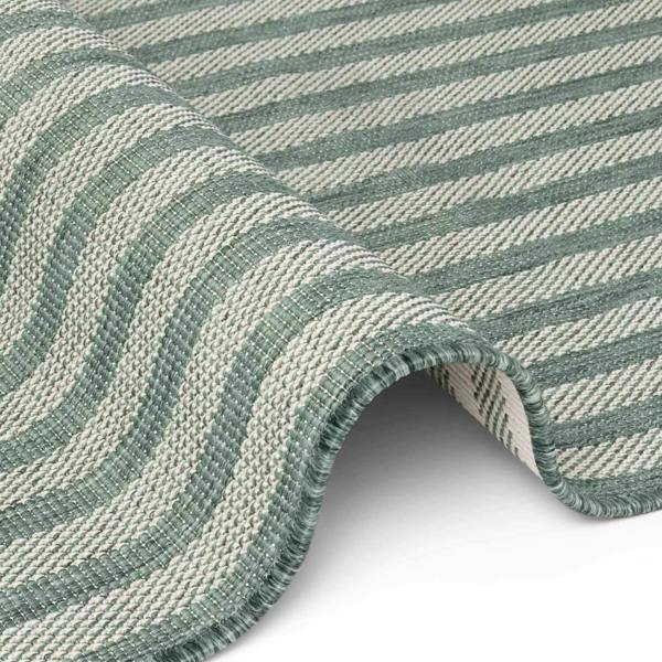 Close-up of a green and white striped fabric roll on a white background