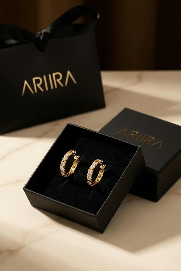 ARIIRA Lorelei Gold Tone Crystal Criss Cross Hoop Earrings