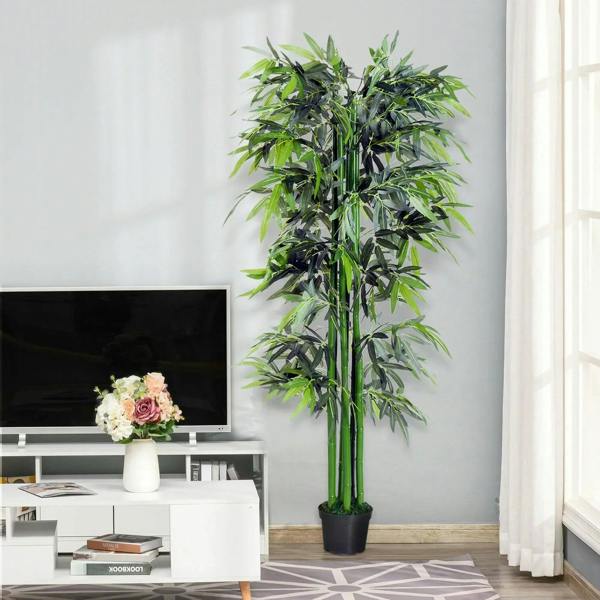 Artificial bamboo plant with green leaves and green stems in a black pot