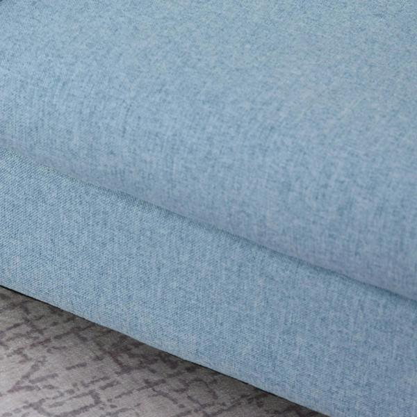 Close-up of blue upholstered armchair cushion fabric and seam detail