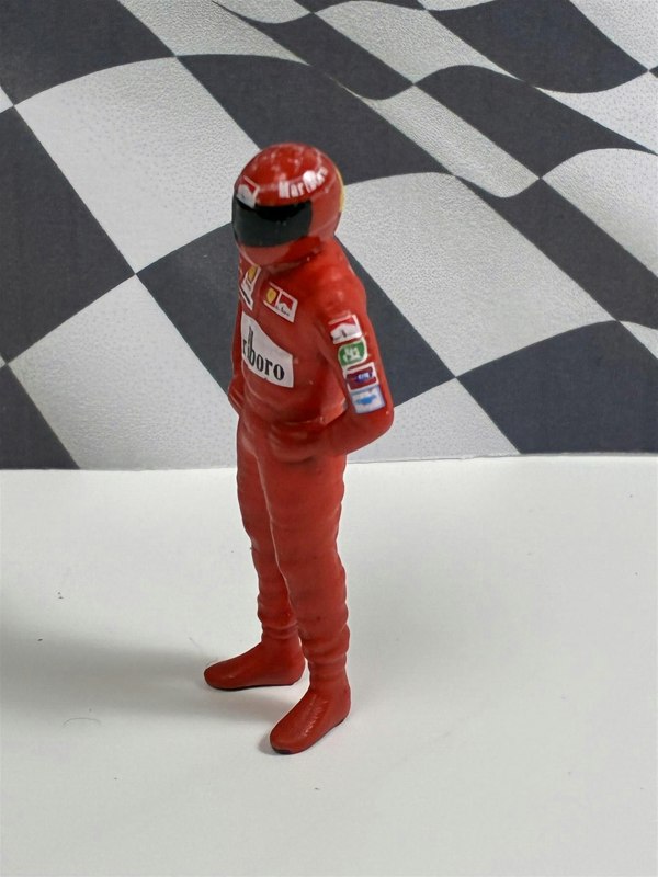 a toy figure of a race car driver