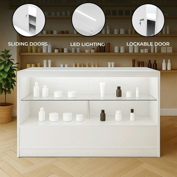 White LED retail shop counter C1500 featuring sliding doors, lockable door, and glass shelves, ideal for displaying products