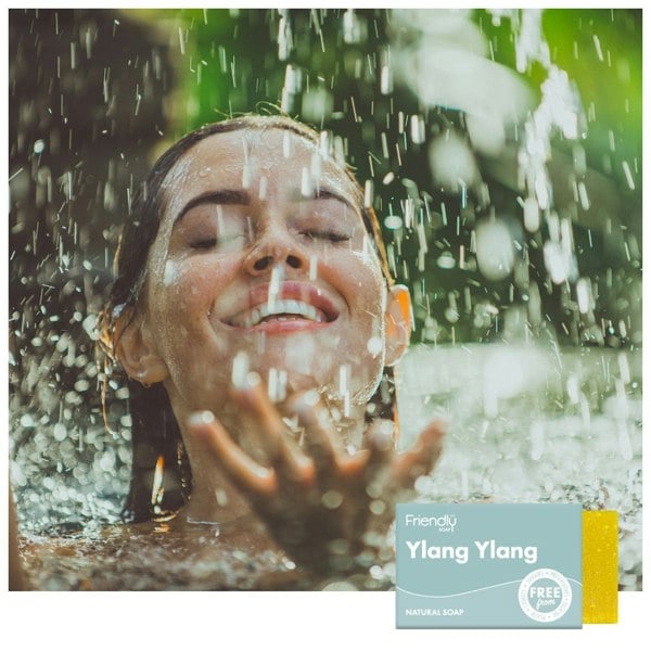 Woman swimming in water with waterfall