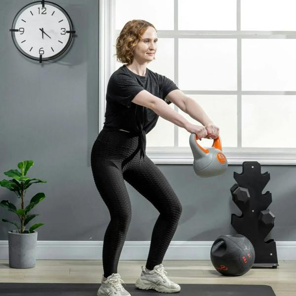 Orange-and-grey kettlebell held for strength training
