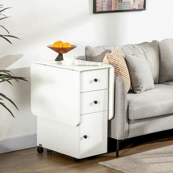 White drop-leaf dining table with side pedestal drawers and cabinet storage on casters.