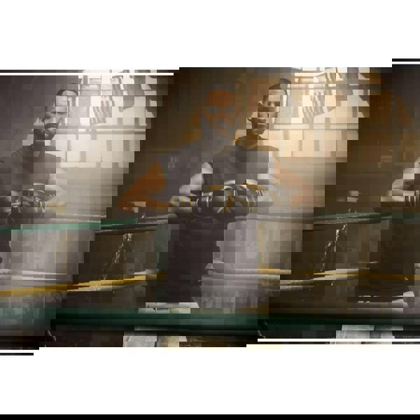 Man in boxing ring wearing a pair of Reebok Boxing Gloves - black/gold