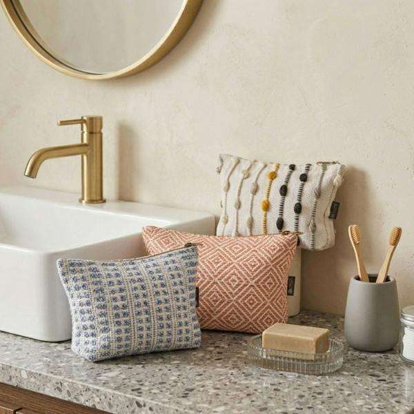 Indigo jacquard toiletry bag with zip-top closure on bathroom countertop
