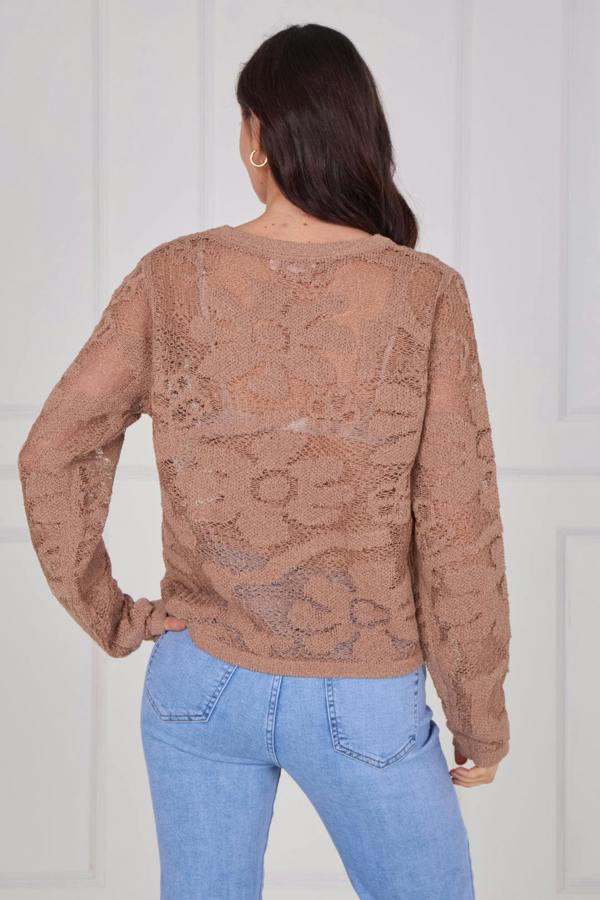 Model wearing a long sleeve crochet top with an open-knit pattern, styled with high-waisted jeans, featuring a relaxed fit and lightweight texture for casual everyday wear.