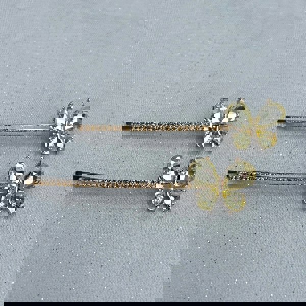 Gold hair slides, butterfly design, yellow crystal wings, long slim barrette style, rhinestone detailing along stem, sparkling decorative accessories, elegant vintage inspired look
