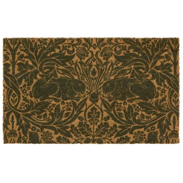 Decorative doormat with intricate black pattern on a brown background