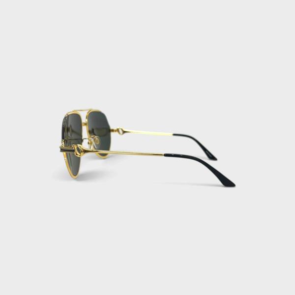 Supplied Fashion rounded sunglasses with gold metal frames and black temple tips, side view on a light background.