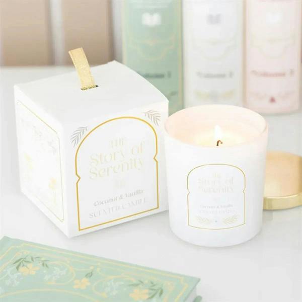 Coconut and vanilla scented candle in white jar with gold lid and label