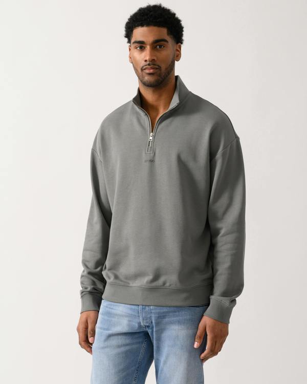 model wearing a HUGO Durty244 Mens 1/4 Zip Sweatshirt in Dark Grey 025