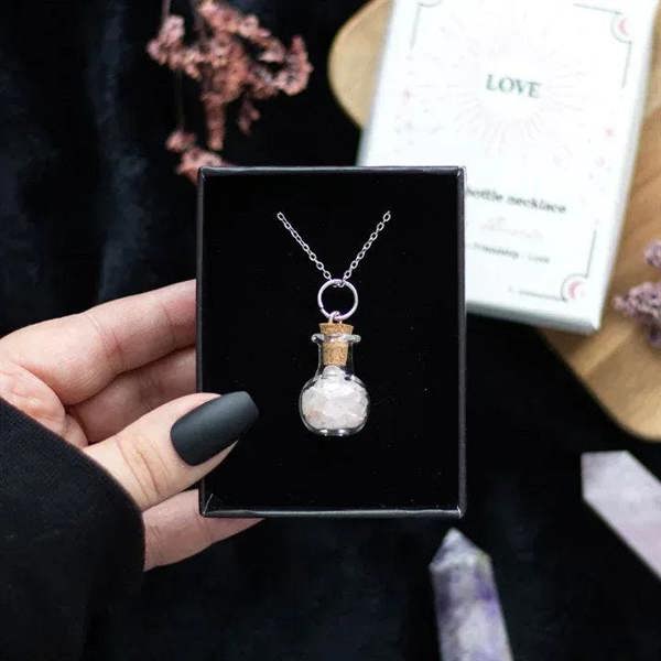 Silver chain potion bottle necklace with pink stone chips and round clasp charm
