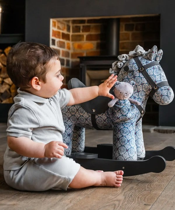 louie & duke baby rocking horse in living room 