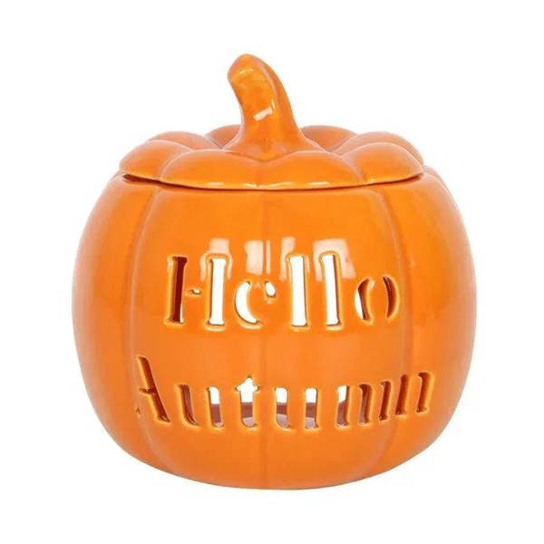 Orange pumpkin-shaped oil burner with lid and cutout lettering