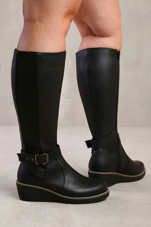 Where's That From Ayleen Wide Calf Wedge Heel Knee High Boots With Elastic Panel in Wide E Fit in Black Faux Leather