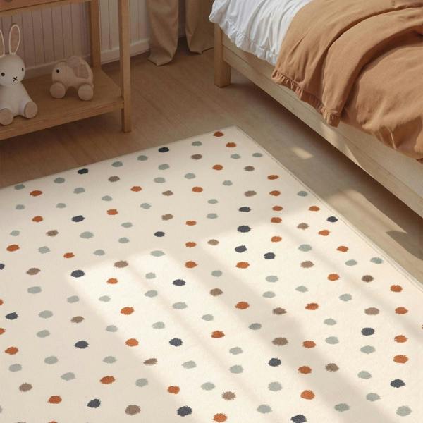 Polka dot rug in a room with a bed and shelf.