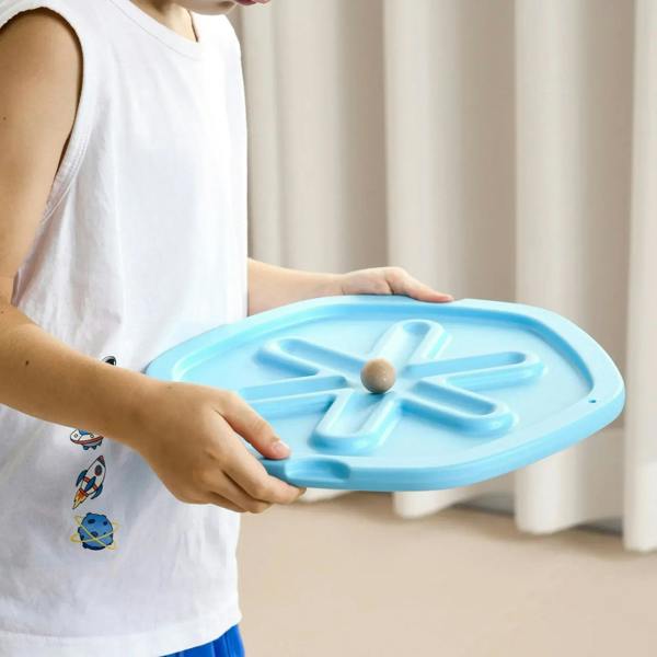 Blue balance board in hands, center wooden ball on textured inner plate