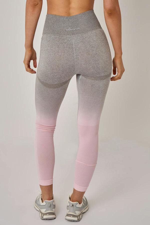 Gray and pink gradient leggings worn by a person on a plain background