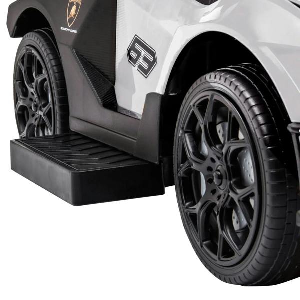 White ride-on push car foot pedal step and front wheel close-up