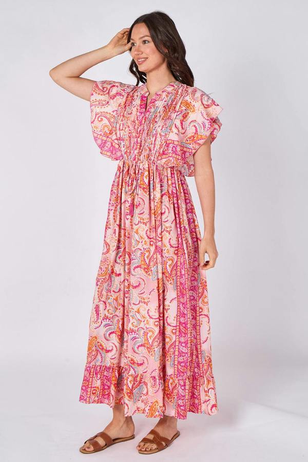 Woman wearing a pink and orange patterned dress on a white background