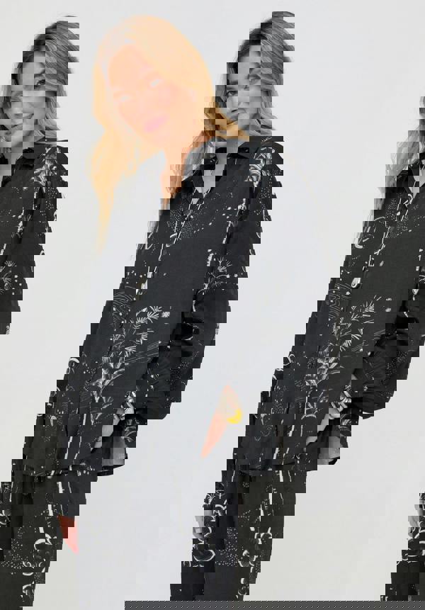 Woman wearing a black floral patterned outfit on a white background