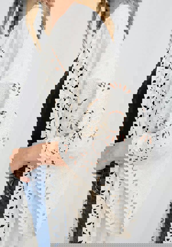 White lace kimono-style garment with cut-out patterns on a plain background