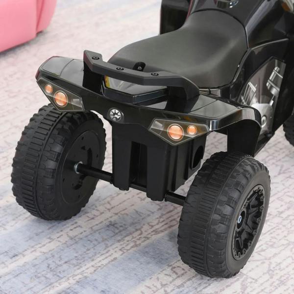 Black ride-on quad with rear orange lights, pedals, and chunky tires