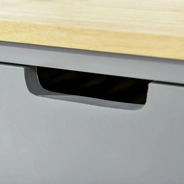 Grey drawer front with curved handle on kitchen utility cart under rubberwood top