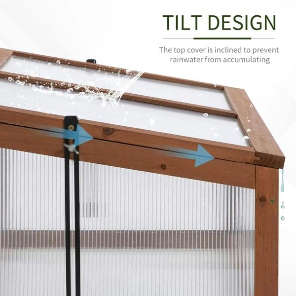 Tilting top lid on a wooden cold frame with clear polycarbonate glazing