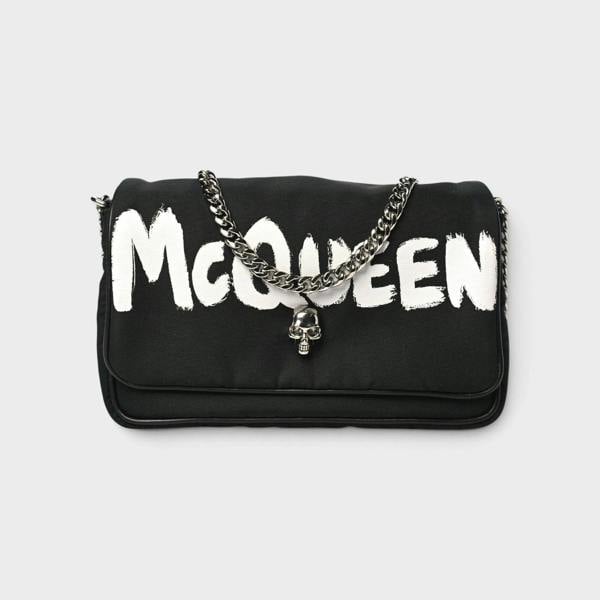 Supplied Fashion black nylon crossbody bag with white graffiti logo and silver skull charm on a chain strap