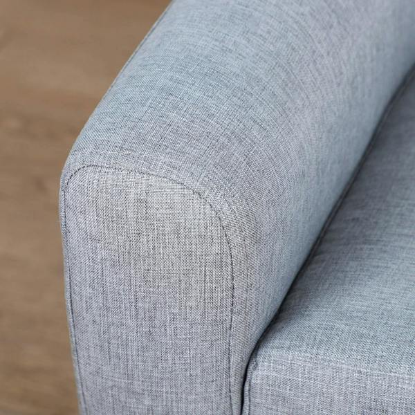 Grey fabric armchair corner with stitched seam and smooth upholstery edge