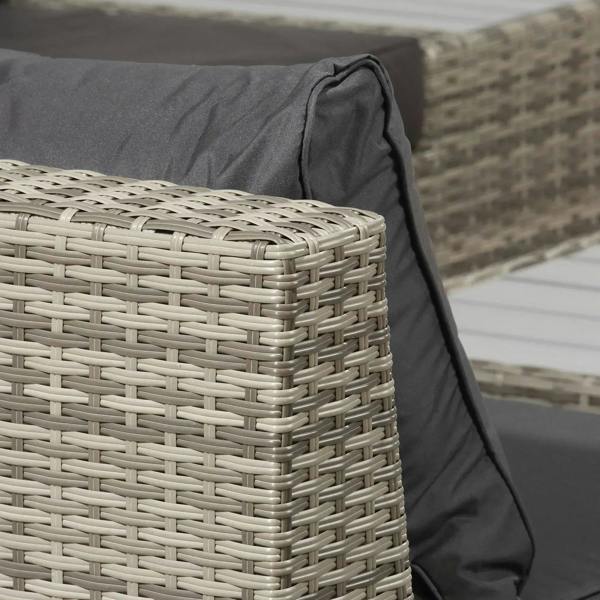 Close-up of light grey rattan armrest with dark cushion and stitched trim