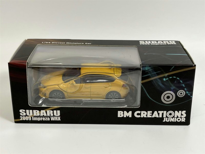 a yellow toy car in a box