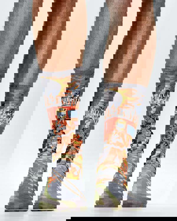 Firefighter-themed socks with a person wearing them on a white background