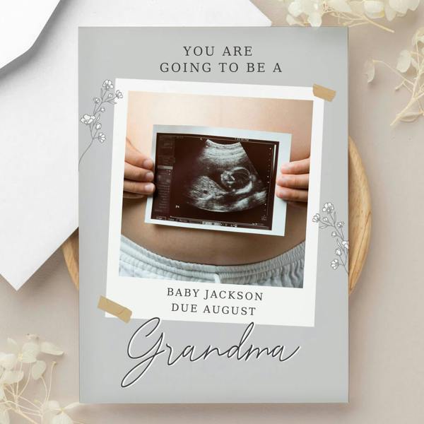 A personalised grey snapshot photo greeting card printed with "YOU ARE GOING TO BE A Grandma" featuring a baby ultrasound photo upload.