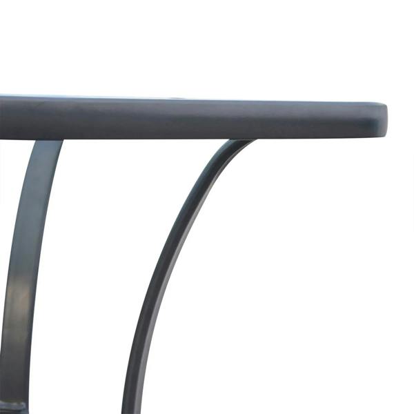 Close-up of black arched metal leg and underside of square glass tabletop