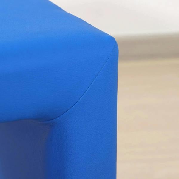 Close-up of blue chair arm and back corner with stitched upholstery seam