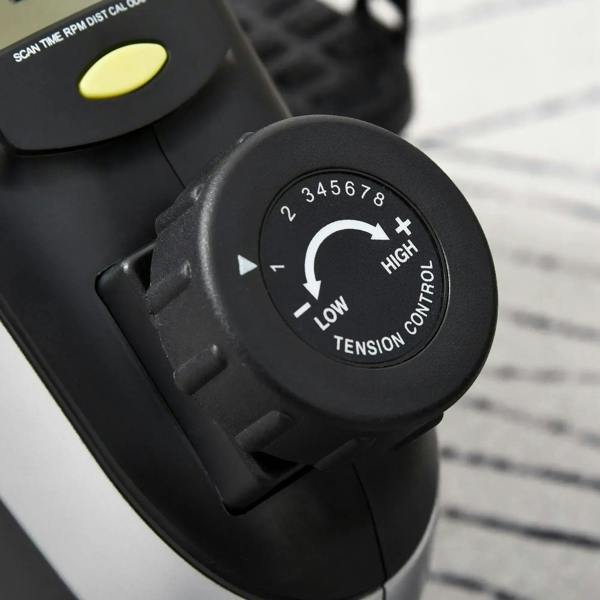Close-up of the tension control dial on the black mini pedal exerciser console