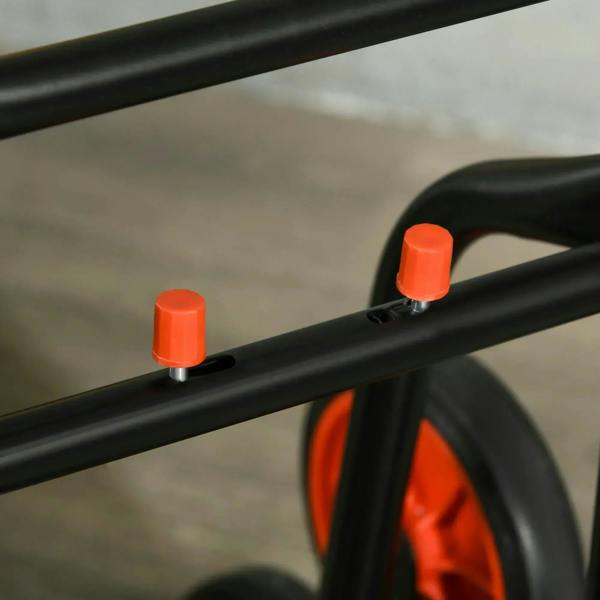 Close-up of hand truck frame with red capped adjustment feet and black wheels