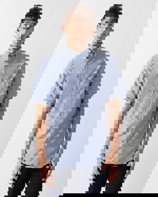 Model wearing a GANT Mens Regular Fit Short Sleeve Oxford Shirt in College Blue