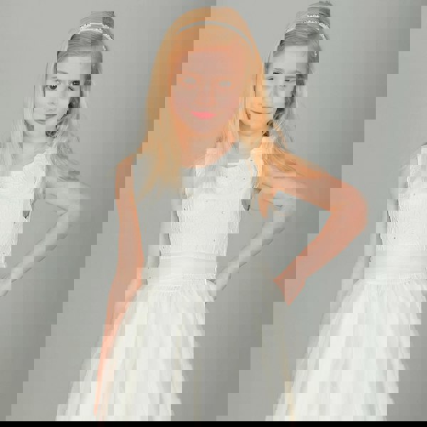 Blonde girl wearing ivory coloured party dress