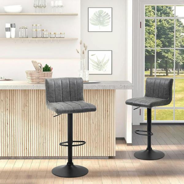 Grey swivel barstool set with black footrests and round bases at a kitchen counter