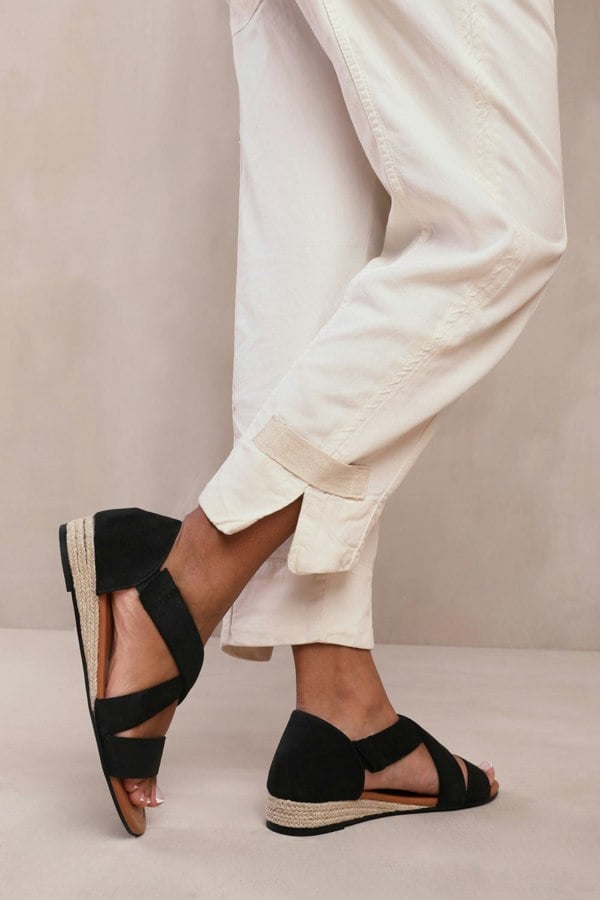 Where's That From Hummingbird Extra Wide Fit Low Wedge Shoes With Cross Over Strap in Black Suede