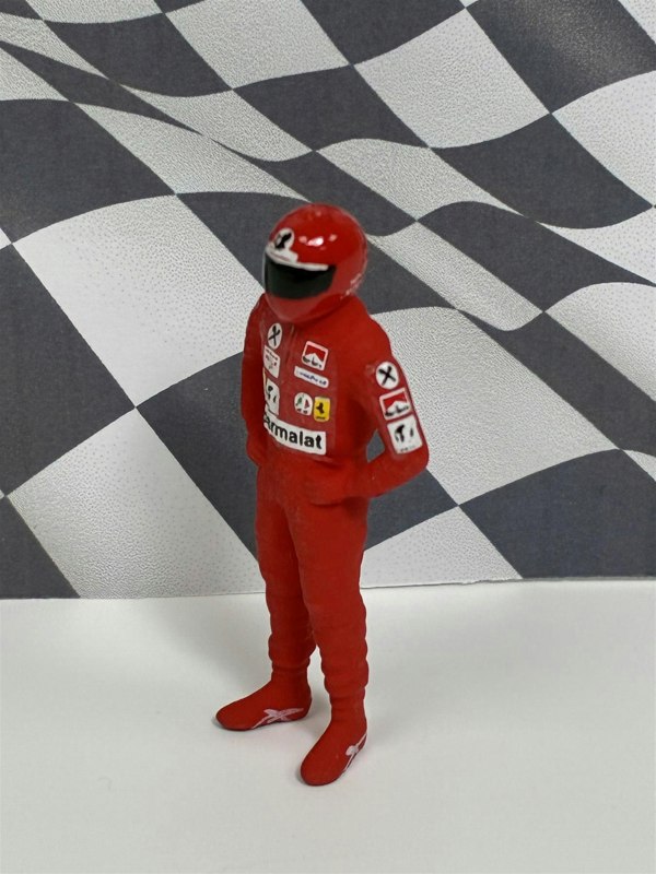 a toy figure in a red suit