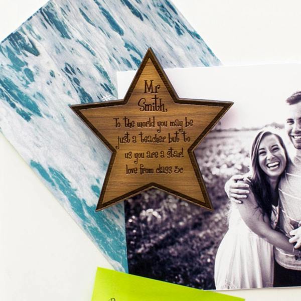 Personalised walnut wood star fridge magnet engraved with a thank-you message for a teacher.