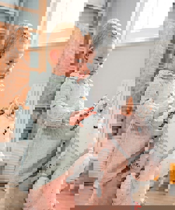 little girl playing with unicorn in playroom 