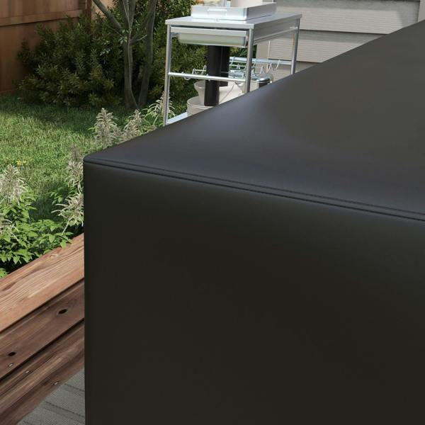Black L-shaped protective furniture cover over outdoor corner bench with neat edges
